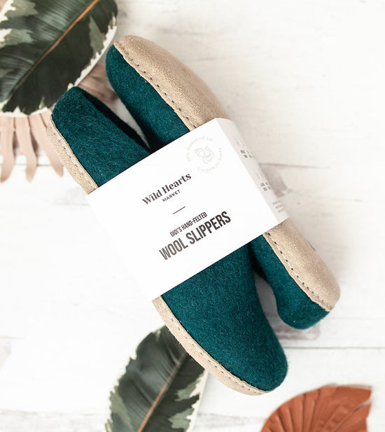 green wool slippers in high end packaging